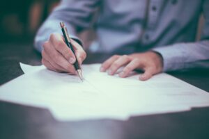 Image of Man Signing Document